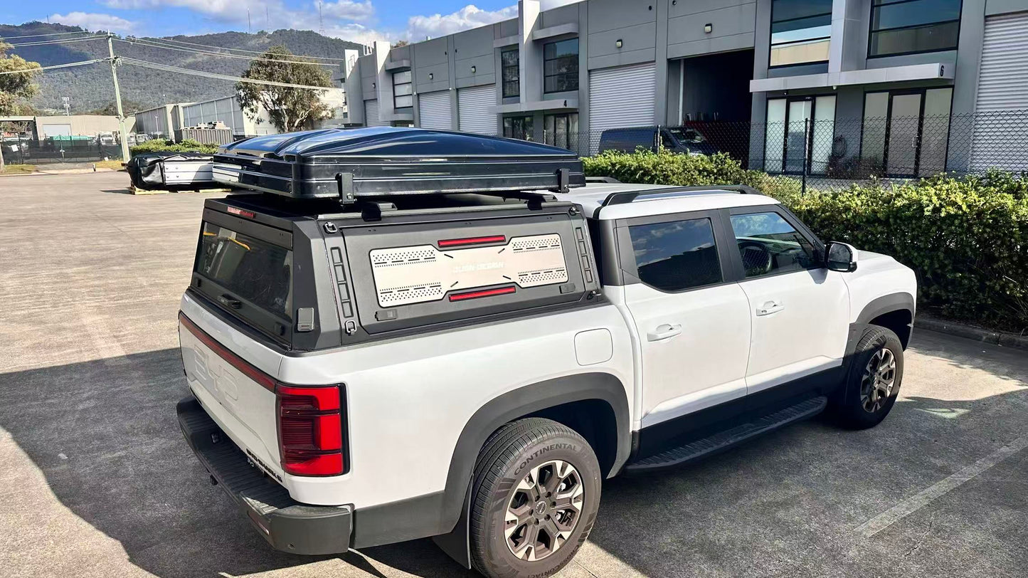 Nomad Camper ABS Hardshell Rooftop Tent | Low-Profile Design.
White truck with a large black rooftop tent in an outdoor setting.